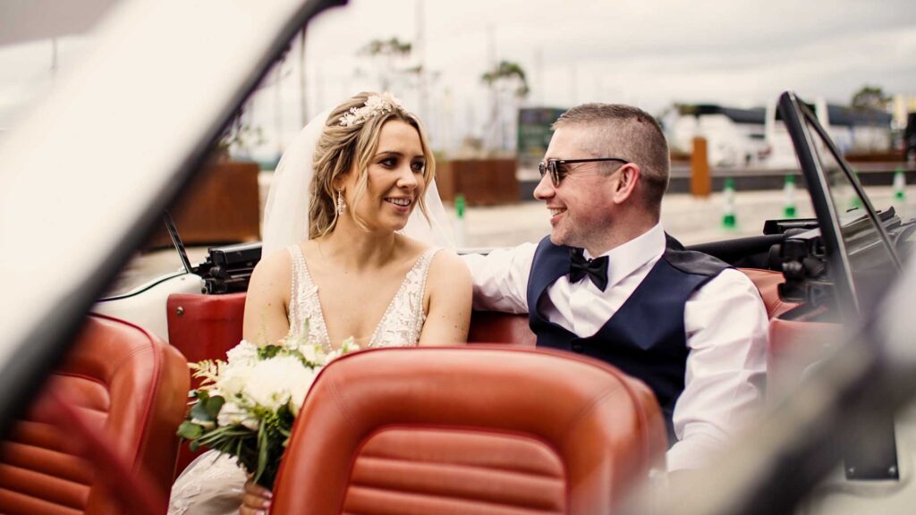 Niall & Claire in their vintage mustang wedding car at the front of the Titanic Hotel Belfast.